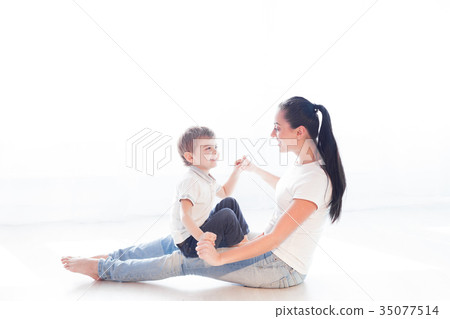 mom plays with her son on the floor of the 35077514