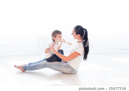 mom plays with her son on the floor of the 35077516