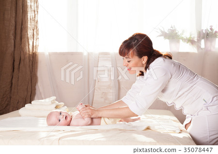 the little boy baby mother doing massage hands and 35078447