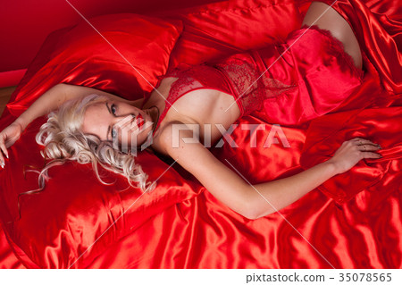 sexy blonde in red underwear lies on a bed sexy blonde in red underwear lies on a bed 35078565