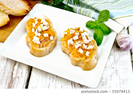 Bruschetta with pumpkin and feta in plate on board 35079413