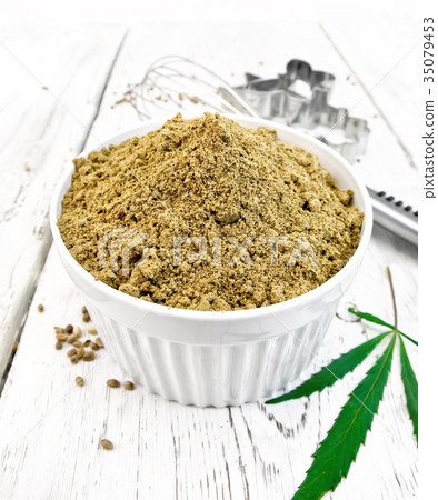 Flour hemp in bowl with leaf on light board Flour hemp in bowl with leaf on light board 35079453