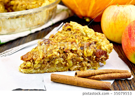 Pie with pumpkin and apples on parchment Pie with pumpkin and apples on parchment 35079553