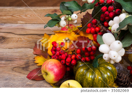 Fall background with snowberry rowan yellow squash Fall background with snowberry rowan yellow squash 35082069