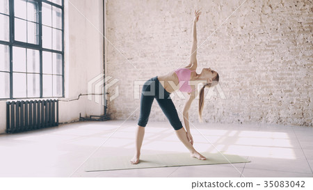 Beautiful yoga girl doing asanas in studio Beautiful yoga girl doing asanas in studio 35083042
