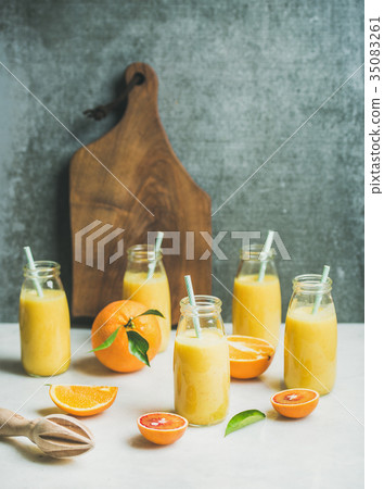 Healthy yellow smoothie with citrus fruit on light 35083261
