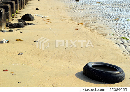 Sandy beach and scrap tires 35084065