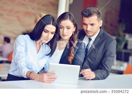 Teamwork process concept.Young coworkers work with Teamwork process concept.Young coworkers work with 35084272