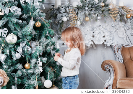 Adorable little blonde girl in a blue jeans 35084283