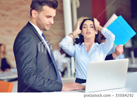 Teamwork process concept.Young coworkers work with Teamwork process concept.Young coworkers work with 35084292