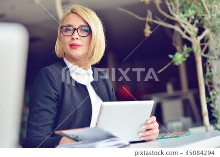 Close-up portrait of active business woman holding Close-up portrait of active business woman holding 35084294
