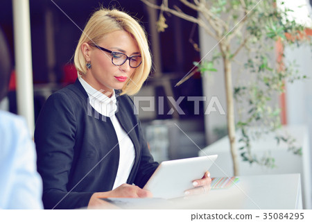 Close-up portrait of active business woman holding Close-up portrait of active business woman holding 35084295