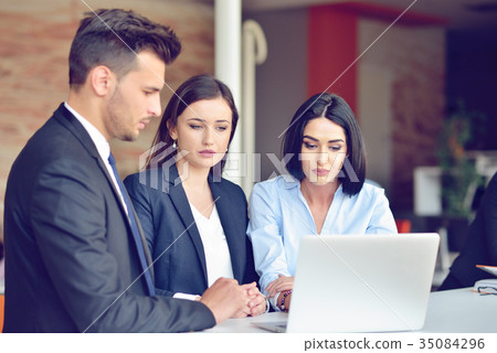 Teamwork process concept.Young coworkers work with Teamwork process concept.Young coworkers work with 35084296