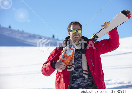 Portrait of healthy man with pair of skis in hands 35085911