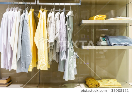 modern wooden wardrobe with clothe hanging on rail 35088121