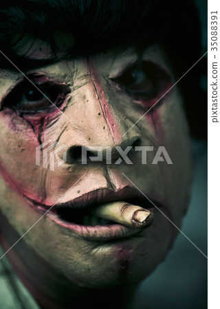 scary disfigured man with a finger in his mouth scary disfigured man with a finger in his mouth 35088391