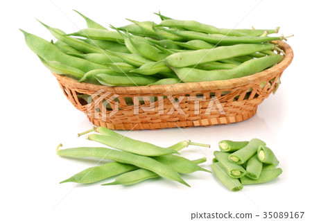 Green beans in a wicker basket isolated on a white Green beans in a wicker basket isolated on a white 35089167