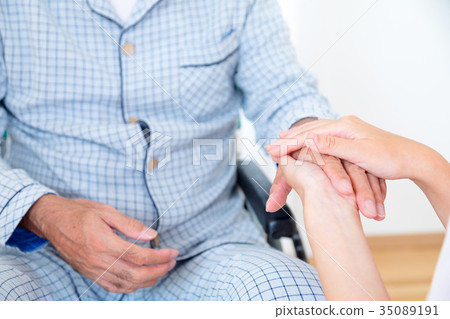 Young nurse and grandpa hold hands Hand touch Retirement home Day care center Wheelchair Young nurse and grandpa hold hands Hand touch Retirement home Day care center Wheelchair 35089191