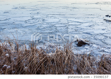 Pieces of ice in lake 35090137