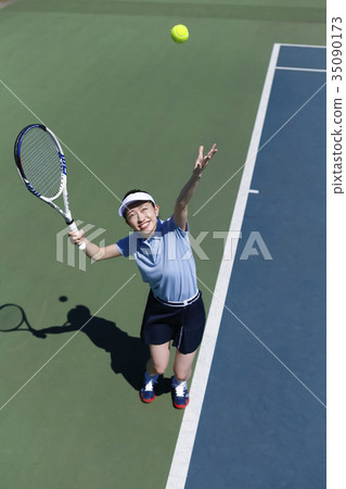 A woman playing tennis A woman playing tennis 35090173