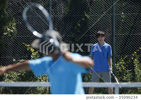 Man and coach playing tennis 35090234