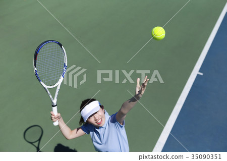 A woman playing tennis A woman playing tennis 35090351