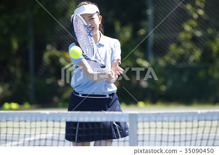 A woman playing tennis A woman playing tennis 35090450