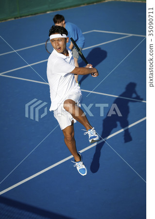 Men playing tennis doubles Men playing tennis doubles 35090711