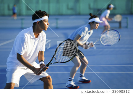 Men and women playing tennis Doubles 35090812