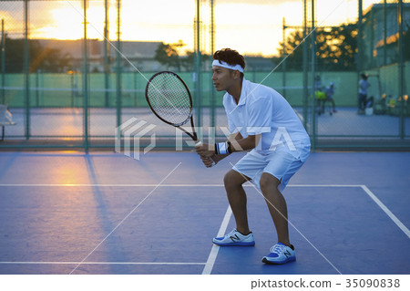 A man playing tennis A man playing tennis 35090838