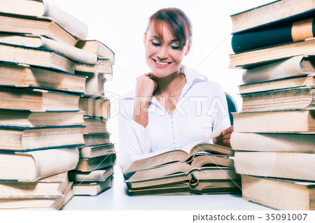 Beautiful young woman with stack of books Beautiful young woman with stack of books 35091007