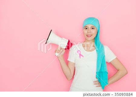 cancer woman standing in pink wall background 35093884