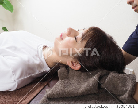 Woman receiving neck massage Woman receiving neck massage 35094391