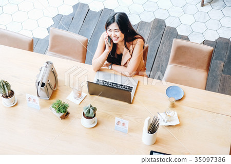 Business asian women using laptop and talking on phone while sit 35097386