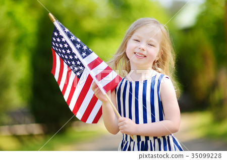 Adorable little girl holding american flag outdoors on beautiful summer day Adorable little girl holding american flag outdoors on beautiful summer day 35099228