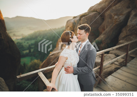 Kissing wedding couple staying over beautiful 35099351