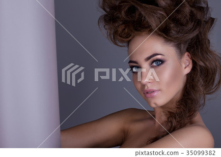 Portrait of a beautiful girl with a creative high hairstyle and 35099382
