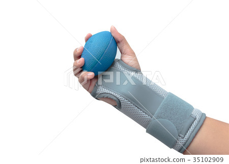 Woman's hand with wrist support squeezing softball 35102909