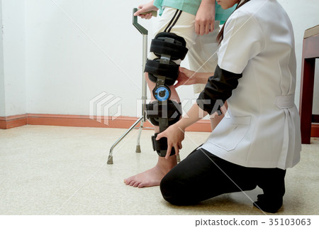 therapist assisting patient woman to walk therapist assisting patient woman to walk 35103063