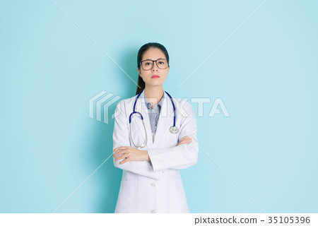 hospital doctor standing in blue wall background hospital doctor standing in blue wall background 35105396