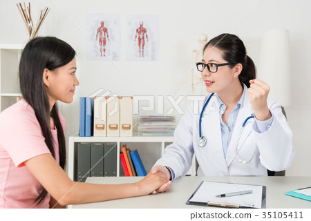 young hospital doctor making cheer up gesture 35105411