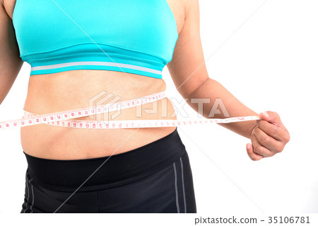 chubby woman measuring her waistline chubby woman measuring her waistline 35106781