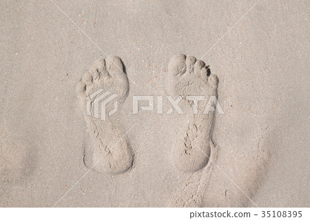 Top view of footprints on sand beach Top view of footprints on sand beach 35108395