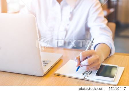 A business woman hand working on a laptop A business woman hand working on a laptop 35110447