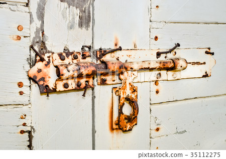 Rusty door handles on wooden door Rusty door handles on wooden door 35112275