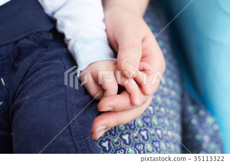Hands of the baby and mom. Gentle touch. A family 35113322