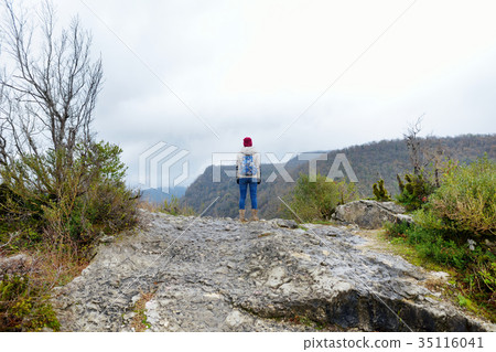 Female tourist hiking on cliff-top promontory above a bend of the Tskhaltsitela River 35116041