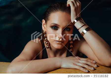 Fashion portrait of a sexy girl in the pool 35118182