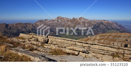 Layered rock and view of the Alpstein range. 35123520