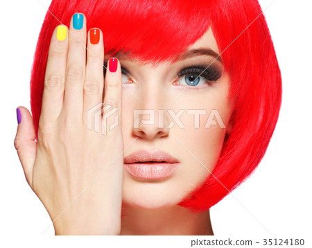 Closeup face of a beautiful  girl with  multicolor nails. 35124180